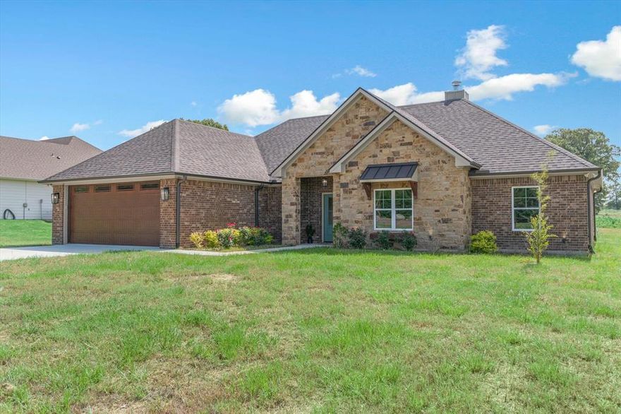 This 2024 complete construction, stone and brick craftsman style home with 4 bedrooms 2 baths on a half-acre, and just a (quick walk) hop, skip and a jump to Lake Holbrook! Gorgeous, eye-catching home has everything you want in a new build! Enter into the living room with vaulted ceilings and floor to ceiling stone fireplace, easy LV flooring, top sash bungalow windows, and an open concept LR, kitchen and dining.  Kitchen has a farm sink, lovely quartz island breakfast bar, countertops, tiled backsplash, custom cabinets, and an amazingly large walk-in pantry you will love!  Separate primary, with tray ceilings, an ensuite bath with dual vanities, soaker tub, walk-in tiled shower and a deep walk-in closet. A mudroom just off the garage, 3 more bedrooms with a guest bath that has dual sinks and tub shower.  Covered back patio looks out to a large half acre lot.  Some extras are electric exterior home lighting making the home gorgeous at twilight. landscaping, long concrete driveway, and finished out garage.  Surrounded by nice homes! Near all the popular restaurants and amenities in the nostalgic town of Mineola!  Mineola ISD!