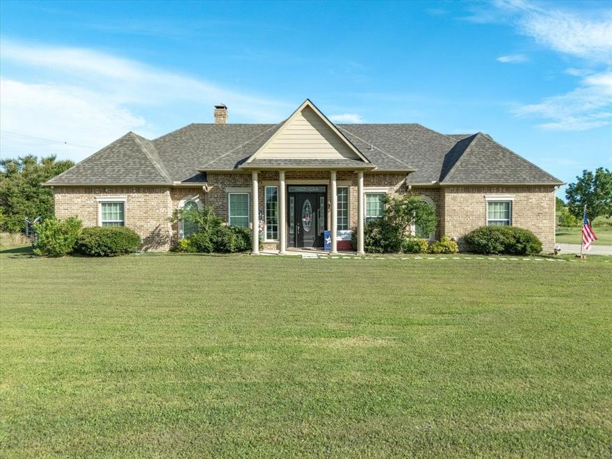 Welcome to country living with modern comfort—just 5 miles from downtown Kaufman, Tx! This custom-built 4-bedroom, 3.5-bath home is nestled on just over 10 acres outside the city limits and offers the ideal balance of space, style, and practicality. Inside, you’ll find hand-scraped hardwood floors, a cozy wood-burning fireplace, and a spacious open layout perfect for everyday living or entertaining. The kitchen features antique-style custom cabinetry, a walk-in pantry, and flows seamlessly into the formal dining room. The oversized primary suite includes a jetted tub, separate shower, dual sinks, and a generous walk-in closet. Upstairs, a large game room offers flexible use as a fifth bedroom, office, or hobby space.   This home is equipped with a 2-year-old roof and a Generac generator for added peace of mind. A finished-out metal building adds versatility, with a 540 sq ft front storage area and a 1,250 sq ft back area previously used as a residence—perfect for a home office, guest suite, or small business. The second building features new AC and septic systems. Both structures are powered by a single electric meter and supported by solar panels for improved energy efficiency. With no city restrictions and plenty of space to live, work, or play, this property is ready to meet your vision of country living.