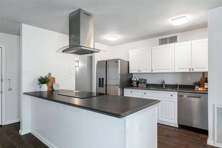 Move in ready and updated. With its original architectural details and warm, inviting atmosphere, this home features a well-maintained interior that blend vintage charm with everyday functionality. The spacious family room is a warm and inviting gathering place, anchored by a beautiful wood-burning fireplace that adds character and charm. The beautifully updated kitchen blends classic style with modern touches, featuring crisp white cabinetry that brightens the space and creates a clean, timeless look. The striking black countertops add contrast and sophistication, offering both durability and elegance. Enjoy a complete kitchen package of stainless appliances. Throughout the home, durable wood-look tile flooring mimics the rich texture of hardwood while offering water resistance and easy maintenance - bringing a cohesive upscale feel to every room.  The updated bathrooms exude a spa-like feel with elegant marble countertops that add a touch of luxury and sophistication. Complementing the countertops is freshly installed tile—stylish and durable—extending across the floors and into the shower or bath surround. The interior of the home has been freshly painted, offering a clean, crisp look that feels bright and welcoming. Soft, neutral tones create a versatile backdrop that complements any style, while enhancing the natural light throughout the space. Please note the newer Windows, HVAC and other components of the home.. Whether you're a first-time buyer, downsizing, or looking for a prime investment opportunity, this small but well-located gem delivers big on potential. Perfectly situated for convenience and lifestyle, this home is located just minutes from a vibrant mix of entertainment and dining options. Whether you're in the mood for a casual bite, a night out at your favorite restaurant, or catching live music or a movie, everything you need is right around the corner.