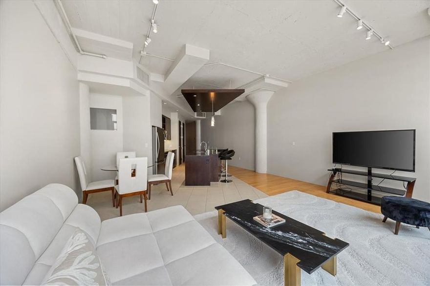 Enjoy the carefree, lock-and-leave lifestyle in this beautifully appointed 1 bedroom, 1 bath residence featuring 1,263 sq ft of spacious, open-concept living. The kitchen and living area flow seamlessly, highlighted by an oversized island with breakfast bar, sleek tile backsplash, and wood and tile flooring throughout. The primary suite includes a bonus flex space, perfect for a home office or reading nook, along with a custom IKEA built-in wardrobe, spa-inspired bathroom, and designer wall coverings. Electric shades in the living area add a modern touch, while expansive windows offer stunning views of 7th Street and the vibrant Montgomery Plaza corridor. This home comes with two reserved parking spaces and access to an array of luxury amenities, including a 24-hour concierge, resort-style pool with cabanas, state-of-the-art fitness center, private movie theater, and elegant resident lounges. Located in the tower closest to the dog park, this unit offers convenience and comfort in one of Fort Worth’s most desirable communities.