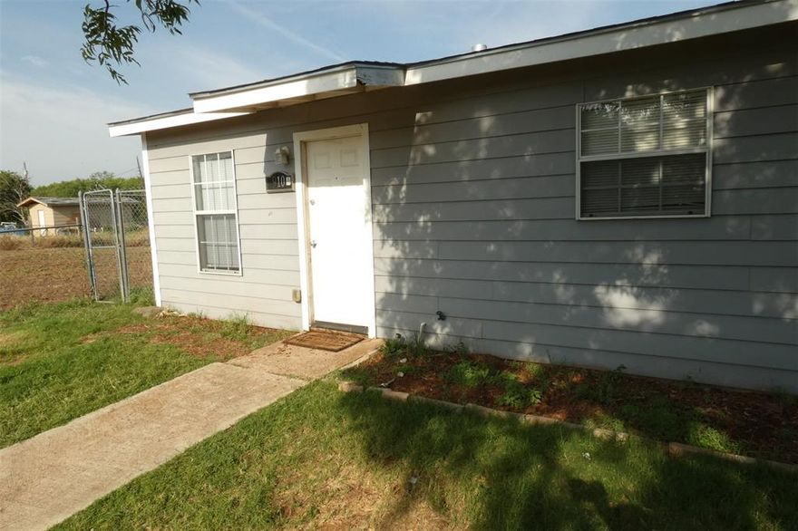 Updated and nice! 2 big bedrooms, separate dining room and big kitchen!!  Lots of updates throughout including cabinets, counters, tile flooring, updated bath, siding and more. Fenced yards front and back. Large double size living area opening to rear yard.  Yard is shared with duplex neighbor. Shared yard responsibility.