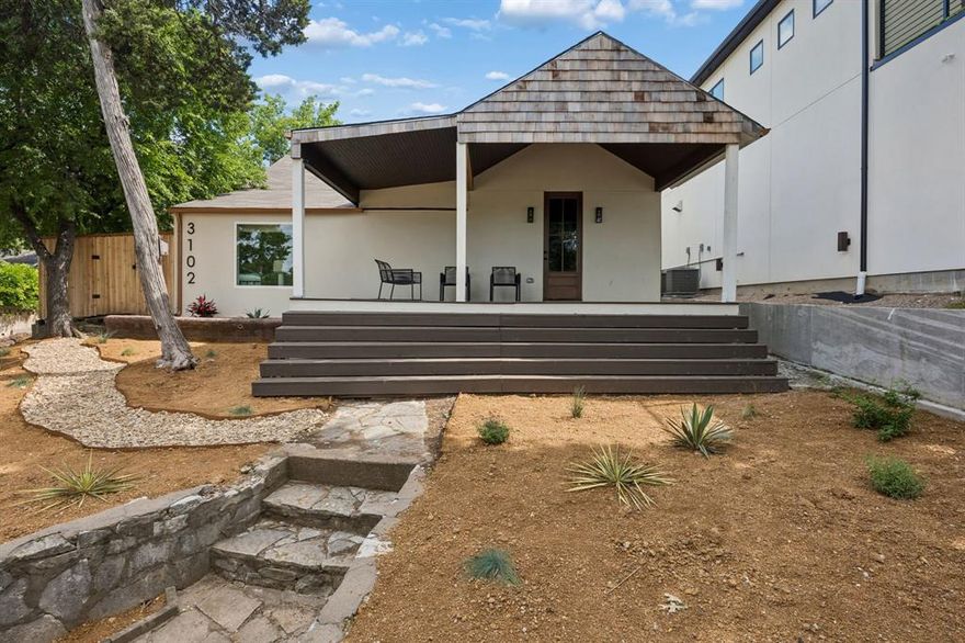 Perched on a beautiful elevated corner lot in the heart of Oak Cliff, this thoughtfully renovated 3-bedroom, 2-bath home perfectly blends timeless character with fresh, modern updates. With an inviting layout designed for everyday living, the home offers abundant natural light, stylish finishes, and versatile spaces, including a unique split-level room perfectly suited to function as either a bedroom or private home office.
The spacious living room features a striking wood accent wall and ample room for entertaining, while the updated kitchen showcases quartz countertops, stainless steel appliances, open shelving, and designer touches throughout. Large closets provide exceptional storage rarely found in homes of this era, while the thoughtfully designed laundry area is tucked away for added convenience and functionality.
Outside, the oversized covered front porch creates the perfect setting for relaxing mornings or evening gatherings overlooking the elevated lot. The backyard offers mature trees, privacy fencing, and additional outdoor living space. Located just half a block from the elementary school and minutes from Bishop Arts, this property presents an incredible opportunity for both owner-occupants and investors looking to capitalize on one of Dallas’ fastest-growing areas.