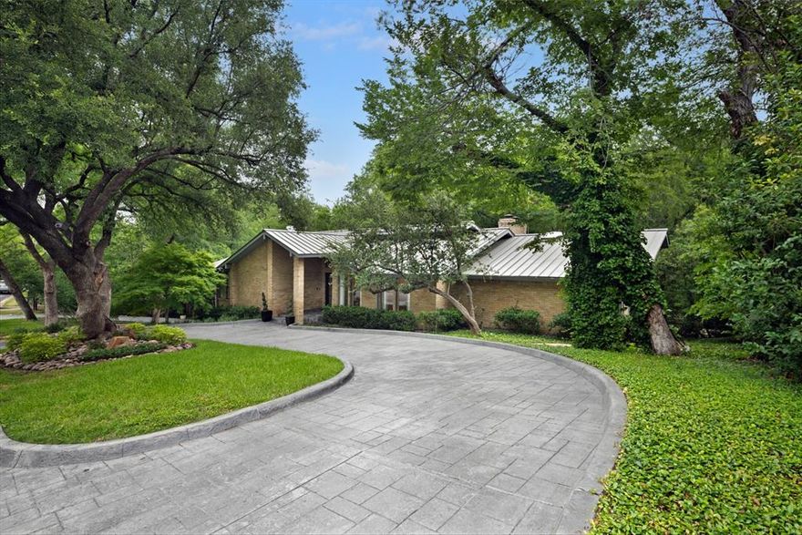 Welcome to 2005 Indian Creek Drive, a post-modern contemporary masterpiece in prestigious Westover Hills. The backyard, designed by famed architects Kingsley K. Wu and Albert S. Komatsu—known for mid-century modern design and the Japanese Garden at the Fort Worth Botanic Garden—adds history, pedigree, and natural beauty.

Built in 1977 and owned by the same family since 1984, this home has never been on the market—until now. A rare chance to own a true work of architectural and landscape art.

From the moment you arrive, the circular driveway and expansive glass windows hint at the serene setting beyond. Inside, the open-concept main level features floor-to-ceiling windows framing sweeping views of the lush backyard.

Set on .66 acres, the backyard is an entertainer’s paradise with Indian Creek, a Japanese tea house pagoda, a plunge pool with waterfall, and multiple decks perfect for indoor-outdoor living.