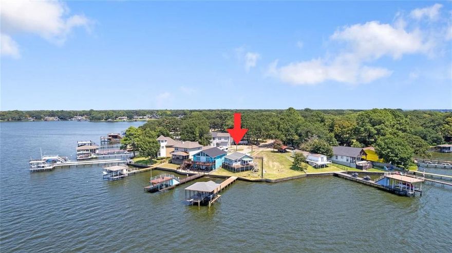 Rare opportunity on the main body of Cedar Creek Lake with panoramic, open-water views you simply cannot recreate. Situated on a quiet cul-de-sac, this prime waterfront lot offers expansive water frontage and incredible sunset views. Property includes a covered dock with lift plus additional space for seating or a picnic table — perfect for enjoying lake days right away. Bring your boat and start enjoying the water immediately while you plan your vision for the property. A 1970s site-built lake cottage offering approximately 747 square feet is included and could be occupied as-is. Whether you choose to occupy, hold, or build your custom lake retreat, the true value here is the irreplaceable open-water location and dock already in place. Main body properties like this are increasingly hard to find. Property to be sold AS-IS. Seller will make no repairs or concessions. Listing agent is owner.