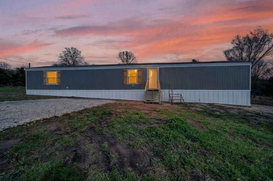 Brand new mobile home situated on just over an acre in the peaceful countryside of Wills Point, TX. This property offers a great blend of privacy and convenience, featuring a newly installed septic system and a gravel driveway for easy access. The home sits among beautiful mature trees that provide shade and a serene setting. With plenty of open space, the land offers endless possibilities for outdoor activities, gardening, or future improvements. Enjoy country living while still being within driving distance of nearby towns and amenities.