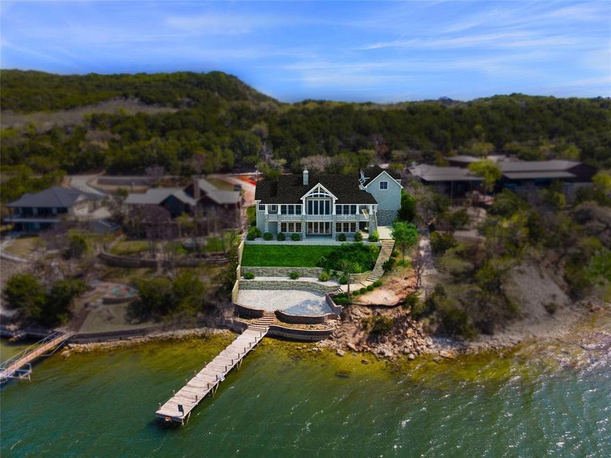 Experience elevated lakeside living in this exceptional LUXURY NEW CONSTRUCTION LAKEHOUSE estate on the Peninsula of Possum Kingdom Lake. A brand new boat dock is being designed and installed. Situated on a 0.533-acre lot, this thoughtfully designed 5,231 sq ft home blends timeless materials with modern luxury and a lake ready lifestyle. The exterior features cedar wood shake and Grey Granbury stone, delivering lasting curb appeal. Step inside to a grand open concept living area with soaring vaulted ceilings and floor to ceiling windows that capture stunning lake views and fill the home with natural light. The chef’s kitchen offers a large island, custom cabinetry, and seamlessly flows into the living space, anchored by a striking stone fireplace, ideal for entertaining or relaxed lake living. The private primary suite on the main level is a true retreat with huge views, dual vanities, and a spacious walk in closet. Above the garage is a separate In Law suite, complete with a kitchenette that adds even more private guest accommodations. Designed for lake life, the home includes wood and tile flooring, a lakeside mudroom entry for easy “drip dry” access, and dedicated storage for lake toys. IMAGINE breathtaking expansive lakeviews from upper and lower covered patios overlooking Broadway, the deepest, widest part of PK LAKE. Perfect for Summer sunsets!