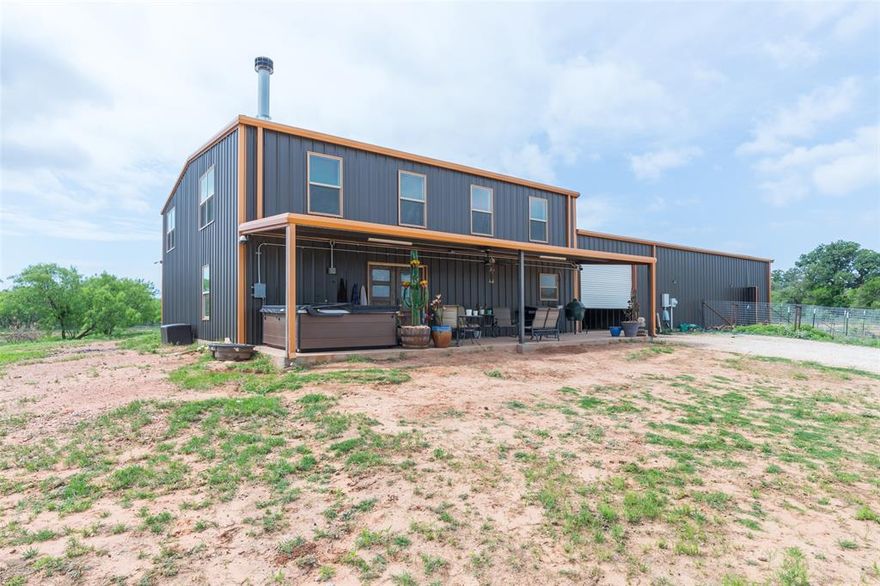 Do you have horses, cows, chickens and goats or do you just long to have horses, cows, chickens and goats? Well if you have them or that is your passion, then this is the property for you! This thoughtfully designed barndominium floor plan  is a fantastic find within minutes of everything in Abilene. Country living on 10+ acres, this 3BR-2.5BA home features an open-concept living and kitchen area with custom cabinetry & wood burning fireplace. Split bedroom floor plan with spacious primary suite & ensuite bath on the first floor and the secondary bedrooms upstairs allow plenty of privacy for everyone. There is an additional half bath downstairs along with a second living space in the loft upstairs. This home is functional and a complete package for your family to move right in.  Ample storage with a large laundry room and pantry and a true safe room are some additional features that make this one special. Exterior features include a covered front porch overlooking a tank & acreage, plus a covered breezeway connecting the house to the barn for convenience for feeding or taking care of livestock. There is ample space for outdoor living in any way that you can dream up. Large covered carport in the breezeway provides room for numerous vehicles, equipment & trailers; there is also a corral and plenty of storage and workshop space in the barn. A large tac room and feed room also house an additional half bath for outdoor convenience. Four roll up doors in the barn area allow for all types of parking ease. There is also RV hookup and parking. The property is fenced for horses and has a play area along with corrals, pens and grazing pasture for all of your animals.  Located minutes from Abilene, with convenient access to everything on the South side of town, this one is the one you cannot afford to wait to see! Schedule a showing today with your favorite Realtor to see all this property has to offer.  With views, convenience, acreage and a great home, what's not to love?