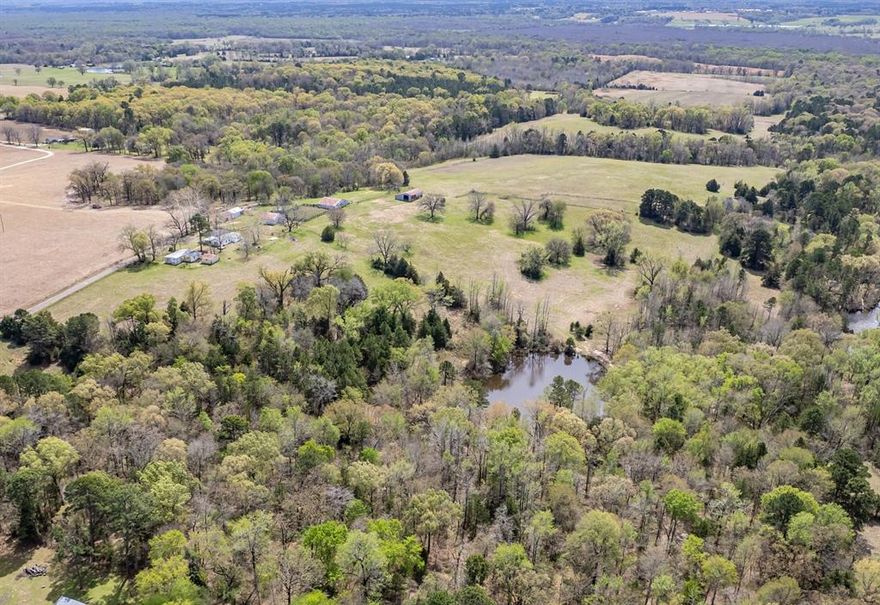 Circle B Ranch - This exceptional 130-acre property offers a rare combination of scenic beauty with productive and recreational opportunities.  Rolling terrain and dramatic elevation changes create breathtaking views across the property, providing several ideal building sites nestled in the trees with 20+ mile views. A picturesque small lake enhances the landscape and attracts abundant wildlife, while a natural watershed offers excellent potential for the development of a future, larger lake. The land has a proven agricultural history, having produced award-winning hay and watermelon crops. Outdoorsmen will appreciate the excellent hunting, with diverse habitat supporting deer, hogs and other native wildlife. Whether you envision a private getaway, a working ranch, or an investment with long-term potential, this property delivers outstanding versatility, beauty and opportunity in one remarkable offering. The views must be seen to appreciate so reach out to the listing agent for a tour of this property that has not been assembled for sale in over 80 years. 

The home on the property and approximately 6 acres are currently excluded from the sale.