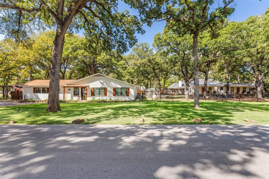 Welcome to this ONE-OF-A-KIND property very near Eagle Mountain Lake. No HOA. NO City taxes. Absolutely beautiful main home with lots of unique interior treatments and designs. Three bedrooms, two full bath plus half bath, amazing kitchen with professional stove, plus two living areas. The main living area overlooks the treed back yard and features stone wood-burning fireplace. Beautifully updated main house plus two cottages. Multi-generational property that is great for Mom or Dad, college kiddos, Bed and Breakfast or long term lease. Situated on a little over half an acre cul-de-sac, this property offers a quiet, tranquil setting with mature trees. Lots of renovation in 2020-2021 including new roof (2019), paint, electrical, interior house plumbing, tankless hot water heater, updated windows (except master bedroom), elevated well head, septic system for main house and cottages, flooring, shiplap, and top-of-the-line Zline gas stove (propane). Both baths in main house renovated. Also, re-grade of both lots for flood mitigation and improved flow to the lake. In 2022-2024, well house was rebuilt, cast iron piping under the main house was replaced, extensive landscaping and fencing was done and the two cottages, licensed as Bed and Breakfasts, were completed.  One of the cottages is a one bedroom and the other is a two bedroom. The cottages have their own gate and entry for privacy. The well-furnished cottages come with stove, fridge, etc. and designed for easy maintenance. Lots of uses and opportunities for the cottages. Please note there are two lots, two tax ID's, and MUST be sold together. Main house address is: 11671 Randle Lane.