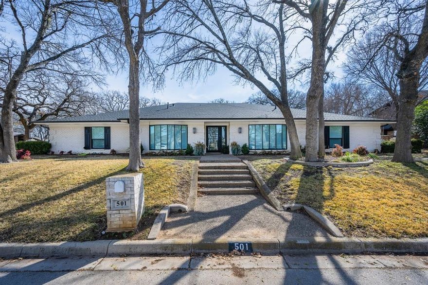 Come and see the crown jewel of Woodhaven Country Club Estates! A palatial ranch style house sitting on hand manicured grounds, the structure is situated facing west by northwest on a corner lot of more than one third acres on iconic and eponymous Woodhaven Ln N. The house is very  conveniently located just a few minutes from Interstate 30, less than thirty minutes from DFW International Airport. This gem has so much to offer! A spacious yet comfortable abode of over forty four hundred square feet which has been meticulously updated with all new double pane windows, new custom made front door, new engineered flooring, new quartz countertops, new custom made built in cabinetry, new lighting and plumbing fixtures, even a newly installed charger for EV vehicles! One of the 5 spacious bedrooms is also an audiophile's dream! It has been customized with highly efficient sound insulation and can be used as a listening room, recording studio, rehearsal space for instrumentalists, or, anything else in which a quiet environment is helpful, like meditation or yoga practice. This stunning home also boasts a large, peaceful mother in law suite featuring a beautifully appointed en suite bathroom. A new water heater which has a six year transferable warranty was just installed to supply the master bathroom and the other full bath located on the south side of the house. The previous owner also had the entire plumbing system replaced and the foundation supported by thirty steel piers installed by the highly rated G.L.Hunt company who have been in business for over 39 years. Their foundation work is backed by a lifetime transferable warranty. The roof is only five years old and the custom landscaping was hand planted and lovingly cared for by the previous owner, who just so happens to be a licensed Master Gardener in the state of Texas. This house is stunning and solid inside and out. Don't miss your opportunity to call this amazing estate your home!