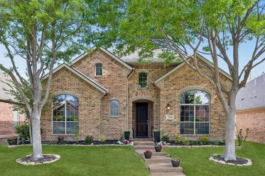 Step into this beautifully appointed Starcreek home in Allen, where warmth and elegance greet you at every turn. Wood floors flow throughout the lower living areas and primary bedroom, complemented by plantation shutters that add charm and style. The vaulted entry opens onto a bright home office, perfect for work or study, while the formal living room features vaulted ceilings and an electric fireplace, creating a welcoming ambiance. The family room is anchored by a dramatic floor-to-ceiling stone fireplace with built-ins on either side, ideal for relaxing or entertaining. The chef’s kitchen shines with a gas stovetop, granite countertops, a large island with a breakfast bar, a bright breakfast nook, and a convenient coffee and tea station. Retreat to the spacious primary suite with ample room for seating, and the primary bath with double vanities, a jetted tub, a separate shower, and a large walk-in closet. Upstairs, a generous game room opens onto a large movie theater, accompanied by secondary bedrooms and baths—perfect for family fun and gatherings. Step outside to the covered patio and enjoy a low-maintenance backyard, perfect for relaxing or entertaining. Located near high-end shopping and dining, and within the Starcreek community with pools, tennis courts, and hiking and biking trails, this home offers the perfect blend of style, comfort, and convenience.