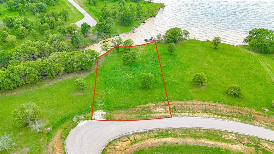 This beautiful waterfront lot in the gated Admiral Shores community sits right on Richland Chambers Lake and is the perfect spot to build your dream lakehouse. It’s tucked into a quiet cove with great views and a gentle slope down to the water. What really sets it apart is that the area in front of the lot has already been dredged, so you’ll have deeper water access—great if you're planning to add a dock or boathouse. Admiral Shores is a peaceful, upscale neighborhood, and this lot gives you that ideal mix of lake life and privacy.