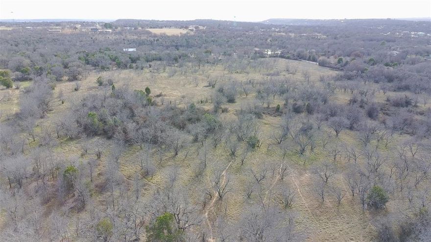 20-acre tract located just outside city limits, with road frontage on two sides. This beautiful property features abundant possibilities, offering privacy and natural beauty throughout. Co-op water and electricity are available, making development or recreational use even more convenient. With no city restrictions, the land offers endless opportunities for residential, agricultural, recreational, or investment use.