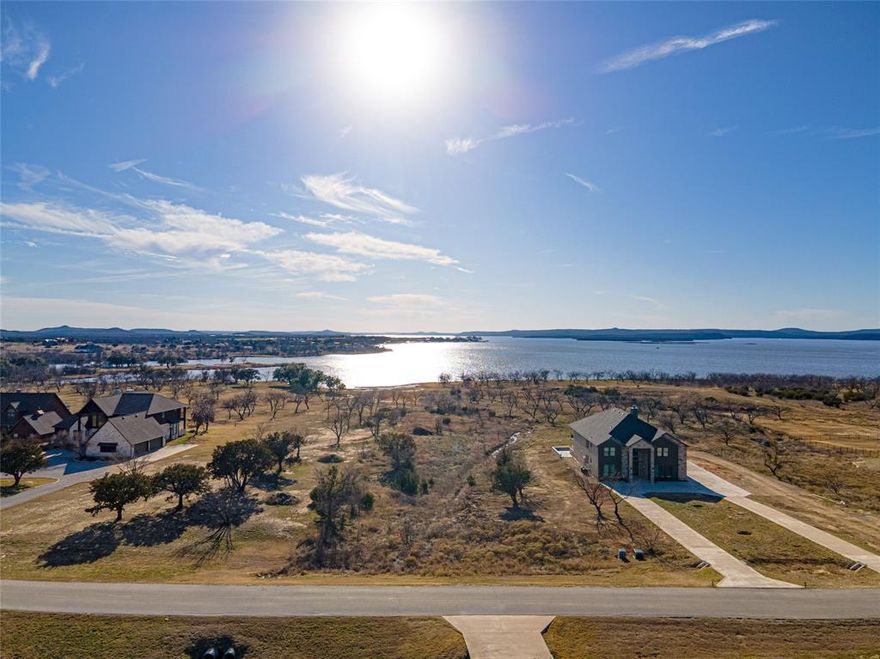 Possum Kingdom Lake: Stunning Lakeview Waterfront Lot!
Welcome to your dream property on the shores of Possum Kingdom Lake! This unique lakefront lot offers breathtaking views of sparkling water, rolling hills, and panoramic sunsets that will leave you in awe. With a spacious layout, you can build your ideal lake home on the front acre while enjoying the freedom of three additional acres of lush greenbelt—perfect for fishing, birdwatching, picnics, outdoor games, and more.
Imagine waking up to serene natural sounds and spending your days enjoying all the lake has to offer. While docks are not permitted directly on this property, you'll still have easy lake access via the community boat ramp and courtesy dock. Additional neighborhood amenities include a gated entrance, an infinity-edge swimming pool, clubhouses, an exercise room, a lakeside park, a boat storage area, and a welcoming community of neighbors.
This lot offers an excellent opportunity to create a space that perfectly reflects your vision. Located just a short scenic drive from Graham, TX, you'll also have access to charming shops, cozy restaurants, and entertainment options nearby.
Whether you're looking for a peaceful retreat or a vibrant lakefront lifestyle, this property has it all. Don’t miss your chance to own a slice of paradise at Possum Kingdom Lake—start building your waterfront oasis today!