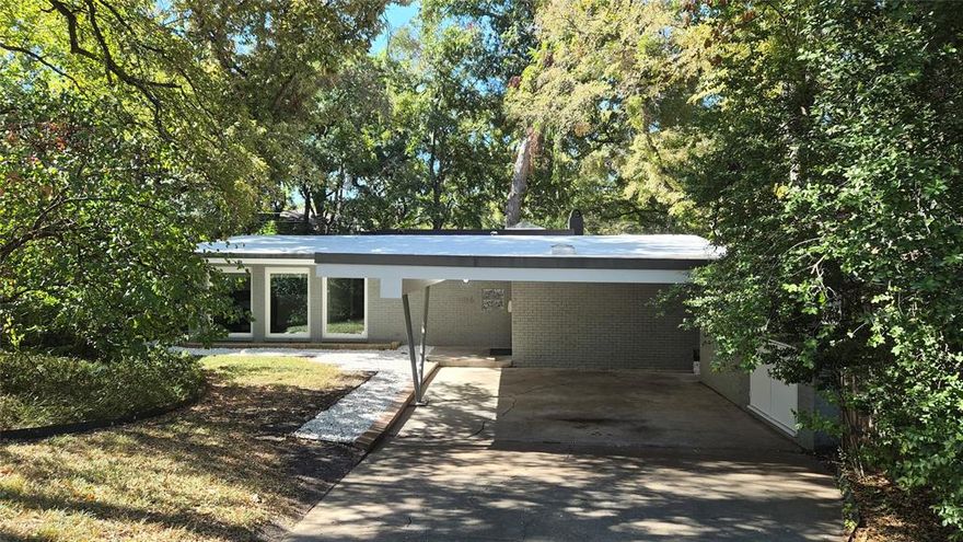 Welcome to 1055 Tipperary Drive — a stunning mid-century modern residence just half a mile from White Rock Lake. Built in 1954 and thoughtfully expanded, this home blends timeless architecture with sophisticated updates and a seamless indoor-outdoor lifestyle. Step inside to discover black-stained hardwood floors that contrast beautifully with abundant natural light pouring through floor-to-ceiling windows. The expansive living room features soaring ceilings and opens directly to a private deck, creating a perfect flow for entertaining or quiet evenings under the trees. The remodeled kitchen is a chef’s dream, featuring soft-close cabinetry, Calacatta quartz countertops, polished black porcelain floors, and stainless-steel appliances. The primary suite includes a versatile office space — ideal for working from home, reading, or relaxing. Recent upgrades include a new roof with skylights, new HVAC systems, LED lighting throughout, and a Wi-Fi programmable sprinkler system. The backyard offers mature trees that provide natural shade and privacy, making the outdoor space feel like a tranquil retreat. Located near scenic trails, parks, and charming cafés, this home offers a rare combination of design, comfort, and convenience in one of East Dallas’s most desirable neighborhoods. The living room sofa and refrigerator will be sold in a private sale and are available to any party that is interested.
