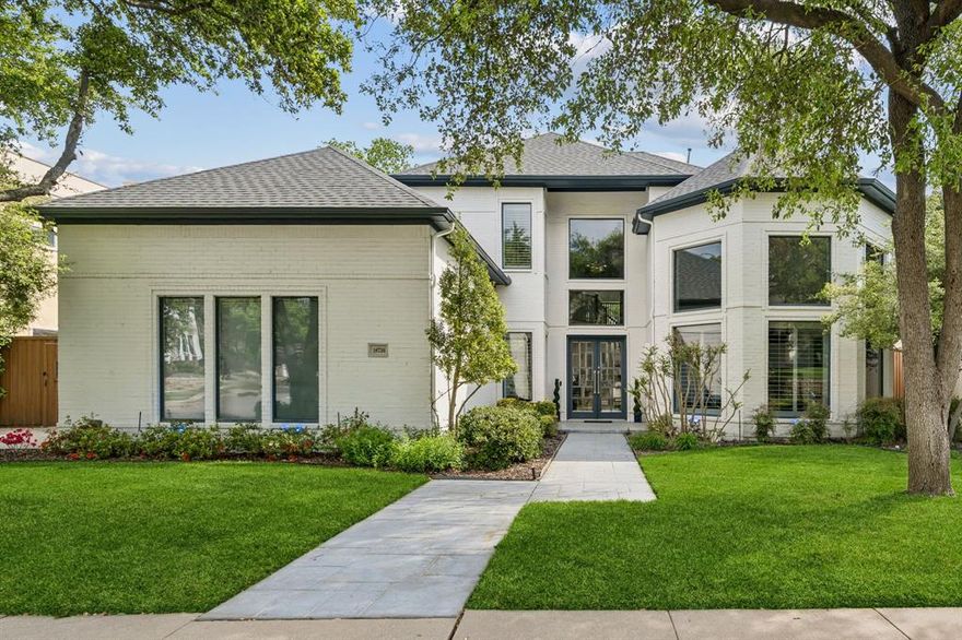 Stunning contemporary modern two-story home in the exclusive gated community of Oaktree in Dallas, offering over 5,500 square feet on a beautifully landscaped lot backing to a serene greenbelt. Designed with both luxury and functionality in mind, this light-filled home features soaring ceilings and a dramatic wall of windows in the main living area, creating a bright and inviting atmosphere with breathtaking backyard views. The chef’s kitchen is a true showstopper, showcasing sleek white cabinetry, white quartz countertops, a large island with breakfast bar, double ovens, gas cooktop, and a built-in refrigerator—perfect for both everyday living and entertaining. The elegant formal dining room is highlighted by a stunning chandelier and a wall of custom built-in cabinetry. The spacious primary suite offers peaceful views of the backyard and includes a sitting area, spa-like ensuite bath with separate vanity areas, and an oversized closet complete with a built-in dresser and a separate cedar closet. A dedicated private office features rich natural woodwork and built-in bookcases, ideal for working from home. Step outside to your own private retreat featuring a beautiful infinity pool overlooking the greenbelt, expansive deck with built-in seating, and a covered patio—perfect for relaxing or entertaining. The home also offers an abundance of storage throughout, plantation shutters, lush landscaping, and a three-car garage. This exceptional property seamlessly blends modern elegance with comfortable living in a premier gated location.