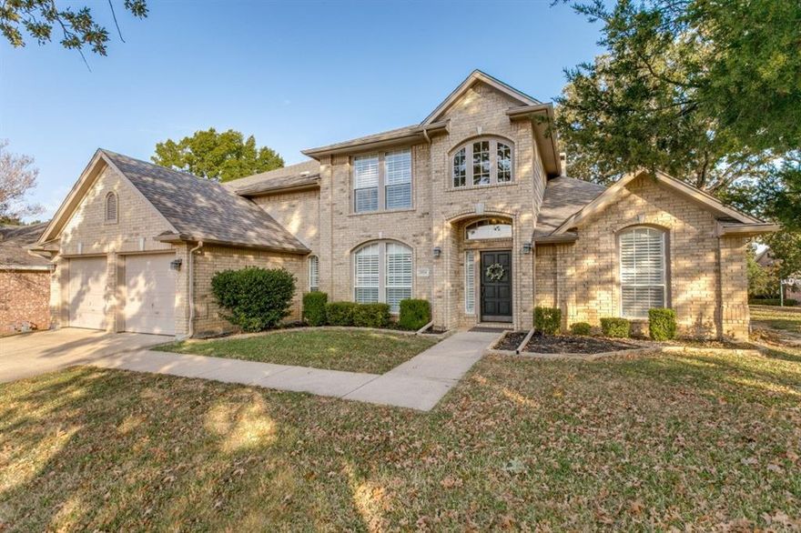 Refreshed and ready! Tremendous VALUE at this price for this neighborhood! Neutral interior color palette, exterior paint and trim repairs, 8 window panes replaced. Now is the time to check out this beautiful home situated on an expansive .275 acre corner lot with soaring trees! Room for everyone in the 4-bedroom, 3.5 bath, 3,323 square feet of functional living space, blending classic charm with modern updates.  Exceptional floor plan; bright, open-concept featuring elegant formal dining and living areas. The formal living room has windows overlooking the inviting pool area and is anchored with a stately see through fireplace connected to a cozy family room offering the warmth of this feature to both rooms. The gourmet kitchen equipped with granite countertops, stainless steel appliances, a large island, and ample cabinetry—perfect for everyday living and entertaining. The master suite is a true retreat featuring its own fireplace and offering a luxurious bathroom with dual sinks, oversized jetted tub, and a spacious walk-in closet. Upstairs additional bedrooms provide comfortable accommodations for family or guests, while a spacious game room adds flexibility for a home office, media room, or play area. Outside, the pool-spa combo has water features creating an intimate and private oasis. 8 foot board on board fence! Located within the highly rated Grapevine-Colleyville ISD and just minutes from Grapevine Lake, parks, shopping, dining, and major highways, this home offers the perfect combination of comfort, convenience, and community.   Time to make a move!