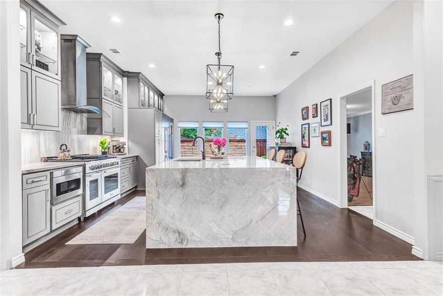 Stunning single story home features $200K in recent updates, including a complete remodel of the kitchen! This gourmet showcase will impress: professional Dacor 6 burner gas range with double convection ovens, Thermador wine refrigerator, built-in Dacor refrigerator and so much more. Other updates include engineered wood flooring, sunken jacuzzi tub and heated floors in the primary bath. The floorplan is open and airy, with the step-down living room, dining and kitchen flowing together to make entertaining a breeze. A versatile exercise or game room features a glass wall and flooring designed for free weights and other gym equipment. Spend your summer lazing by the pool with refreshing waterfalls or lounging under the covered patio. The primary suite also offers a custom plank wall with floating fireplace. A private family room offers exceptional pool views. Fabulous location close to DNT and 121!