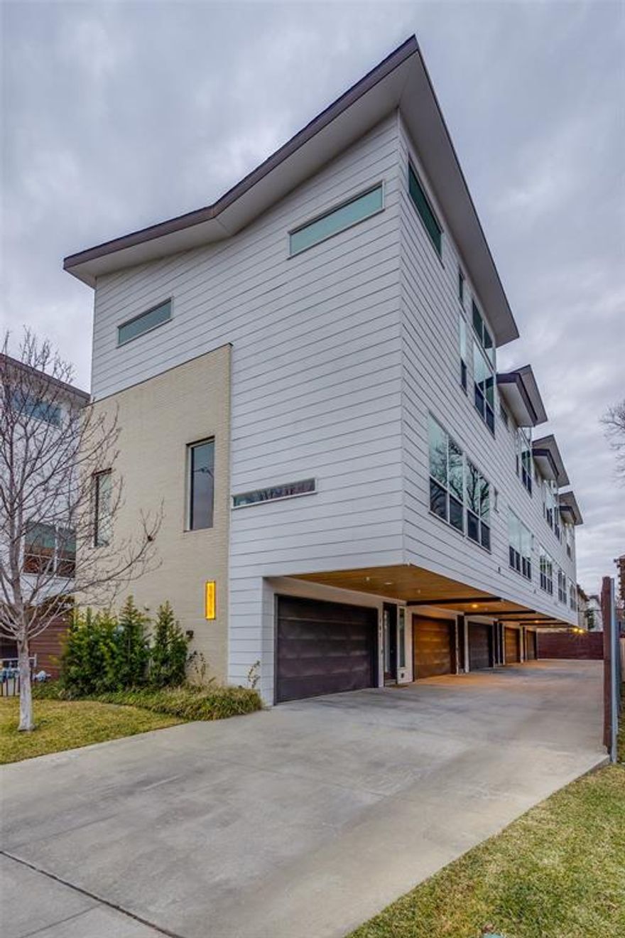 Sophisticated modern townhome ideally located within walking distance to Greenville Avenue’s most popular restaurants, bars, coffee shops, and boutiques. This beautifully maintained residence has been thoughtfully reimagined and enhanced with over $20K in upgrades, offering an exceptional living experience. Soaring 11–14 ft ceilings and massive windows flood the open-concept living spaces with abundant natural light.
Step outside to a reimagined, landscaped backyard patio, creating a private outdoor oasis ideal for relaxing or hosting guests. This exceptional townhome combines prime location, modern elegance, and quality upgrades—an East Dallas must-see.