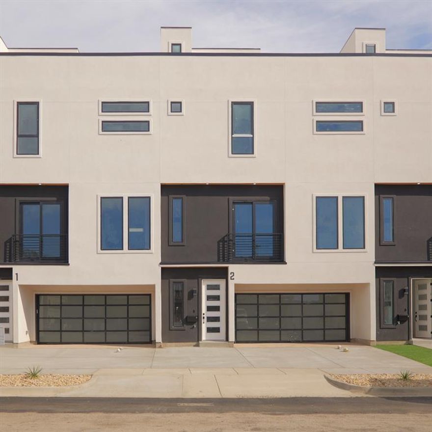 Brand-new luxury 4-story townhome in Old East Dallas East Village with skyline views, private yard, and an oversized rooftop deck. This modern 1,700+ sq ft home sits steps from restaurants and minutes from the new “Central” mixed-use development by De La Vega. Estimated completion mid-December.

The first level features a true 2-car garage (approx. 20’ deep x 16’ wide), a flex-office room, and direct access to a private turfed yard with a gas stub and 6–7 ft privacy fencing. The home is spray-foam insulated for energy efficiency.

Level two offers an open-concept living area with abundant natural light, a Juliet balcony with skyline views, a designer half bath, and a full kitchen with light walnut cabinetry, white quartz counters, luxury vinyl plank flooring, and a 12+ ft quartz island that seats four comfortably. Complete LG stainless appliance package included.

Level three features both bedrooms, a full laundry area with washer and dryer included, a guest suite with tub-shower, and an elevated primary suite with Downtown Dallas skyline views. The primary bath includes dual shower heads and modern finishes.

The fourth level includes the spray-foam insulated mechanical and storage room and access to a large rooftop deck built with proper drainage slope and panoramic skyline views.

Located in a rapidly growing pocket near Lower Greenville, Deep Ellum, Uptown, and Knox-Henderson, this townhome combines modern design, thoughtful livability, and unbeatable proximity to Dallas dining, retail, and entertainment.

Move-in ready mid-December. Be the first to live in this brand-new luxury build.