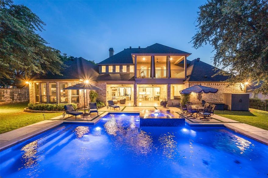 Welcome to a rare gem in the heart of Southlake’s prestigious Shady Oaks neighborhood! This refined and sophisticated home sits on nearly half an acre of a beautifully landscaped corner lot, offering unmatched curb appeal and thoughtful luxury throughout. Boasting 5 spacious bedrooms, 6 full baths, and a half bath, this residence features soft neutral tones, hand-scraped hardwoods throughout most of the home, and soaring ceilings. The elegant entryway showcases a grand wrought iron staircase and open floorplan with expansive views of the custom J. Caldwell pool, wrapped in striking blue tile.
No detail was overlooked—this home includes a 24 KW Generac generator, a Class 4 hail-resistant roof, and a 4-car oversized garage. The chef-inspired kitchen is a dream come true, featuring two large islands, quartz countertops, Wolf double ovens and Wolf 6-burner range with griddle, Bosch dishwasher, Sub-Zero refrigerator, KitchenAid brand wine fridge, KA trash compactor, KA built in ice maker, and abundant custom cabinetry. Host gatherings with ease in the formal dining room, complete with wine grotto, butler’s pantry, & a stunning Arhaus chandelier. The private study offers custom built-ins, 2 built in desks, storage, and rich hand scraped hardwood flooring. Downstairs also features a fully equipped media room, laundry room with dog-washing station, & a guest suite with en-suite bath. The owner's suite is a true retreat, with views of the pool, a spa-like bath with dual vanities, two-head shower, & oversized walk-in closet. Upstairs, enjoy 3 additional bedrooms, a massive game room with wet bar, wine fridge, built-ins, desk, and access to a large balcony.
Step outside to a covered living area with fireplace, phantom screens, Viking 36” grill, gutters have installed leaf guards, and a resort-style pool with spa, sun shelf, water feature, custom lighting, and heating. Luxury, comfort, and function meet in this exquisite Southlake estate—schedule your private tour today!