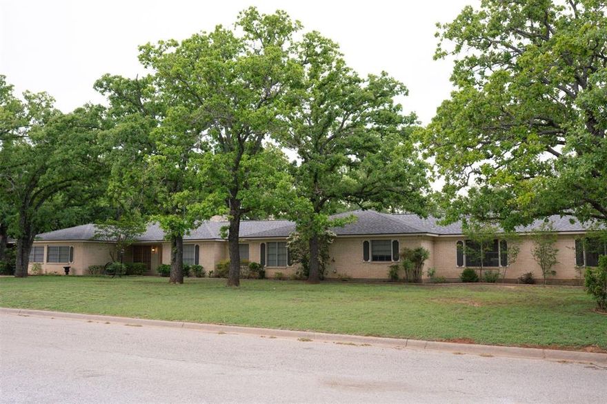 Welcome to this amazing 4,033 Sq Ft brick home featuring 5 bedrooms (3 of which include an en-suite bathroom) and 4 bathrooms, perfectly situated on a 33,000 sf corner lot in Eastland's most sought after neighborhood.  Surrounded by beautiful mature trees and enhanced with fresh paint and new flooring throughout, this home offers the perfect blend of comfort, space, and style.  Inside, you will find two spacious living areas, a cozy wood burning fireplace, and abundant storage throughout.  The expansive floor plan is ideal for both everyday living and entertaining.  The large primary suite is a true retreat, complete with an ensuite bathroom and his and hers walk in closets.  Step outside to your own private backyard oasis featuring an in ground pool with all new equipment, hot tub, and incredible outdoor living space with lush landscaping, perfect for relaxing or hosting guests.  Additional highlights include rear parking and an attached three-car garage with added storage.  The detached bonus building with 650 square feet of space plus a single car garage, offers plenty of room as a work shop, art studio, hobbies, storage, in-law unit or ADU, (Accessory Dwelling Unit) with potential income producing living space.  This home is HUGE and truly has it all inside and out.