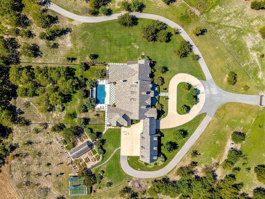 T4 Farm in Tarrant County has just been reintroduced at $6,500,000, making this one of the most compelling luxury land offerings of 2025. Rarely does a property of this caliber—combining unmatched location, premier improvements, and extraordinary lifestyle potential—come available at such an attractive value. This is more than a price change; it’s an invitation to secure one of the region’s most significant estates at an exceptional offering. Truly the opportunity of the year, and one not to miss. T 4 Farm, an incredible 63 acre estate truly offering it all, plus easy access to the Chisholm Trail Parkway. Entering the farm, you notice the landscaped and well-stocked pond. The paved road leads to the French Country Manor and the heart of the farm. This centerpiece is spacious and comfortable, incorporating great taste with thoughtful features and bespoke details. Vaulted ceilings, wide doorways, and stunning natural light offer all of the right ingredients for family life and the best of entertaining. Bonus primary suite closets, and a wine room that dreams are made of! Out back is an impressive and relaxing landscape design with a pool, patio, kitchen, custom greenhouse, raised bed garden, chicken coop, and a guest apartment above the garage. The property is high-fenced and capable of containing any assortment of animals. The multipurpose barn has a workshop area and gym on the first floor as well as living quarters and a great entertaining space upstairs.