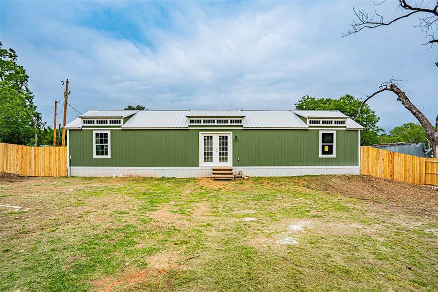 Wonderful brand-new manufactured home by name only! Built with all-wood construction and a durable metal roof, this home offers quality craftsmanship and modern finishes throughout. Features include 2 very large bedrooms and 2 full bathrooms, including a spacious primary suite with ensuite bath. The huge walk-through utility room provides extra cabinets and countertop space for added storage and convenience. The kitchen features all brand-new cabinetry and finishes, and everything in the home is new and professionally completed up to code. Energy-efficient mini split AC and heat systems provide comfort throughout the home. Two brand-new porches have also been installed since the listing photos were taken. This home offers the feel and quality of a site-built home at an affordable price. Great opportunity and a tremendous value!