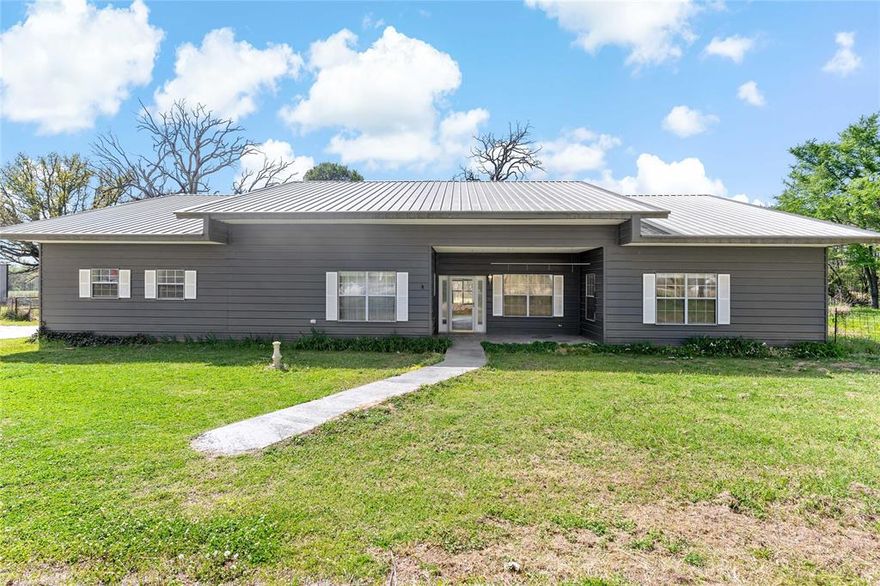 Set on 11 scenic acres near the Sulphur River, this spacious 5-bedroom, 2.5-bath home offers the perfect blend of comfort, functionality, and country living. With 3,127 square feet of living space, the home features a durable metal roof and siding, along with a welcoming porch and patio—ideal for enjoying quiet mornings and wide-open views.

Inside, you’ll find ceramic tile flooring throughout, providing both style and easy maintenance. The thoughtfully designed layout offers generous living areas, a well-appointed kitchen with custom cabinets and gas range, and ample room for family and guests.

Split bedroom arrangement. Primary has en-suite bath and walk in closet. Additional 4 bedrooms on the opposite side of the home. Three additional rooms for office space or hobbies!

For those needing workspace or storage, the 40x60 metal shop is a standout feature—perfect for equipment, hobbies, or a home-based business.

Whether you’re looking for a private retreat, room to roam, or a property with versatile utility, this one checks all the boxes with its combination of acreage, quality construction, and proximity to outdoor recreation.