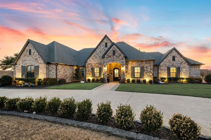 Experience refined luxury living in the award-winning Mustang Lakes community. This exceptional Dave R. Williams custom-built, single-story estate sits on over an acre and seamlessly blends elegant design with modern comfort, all within highly sought-after Prosper ISD. The open-concept floor plan is filled with natural light and thoughtfully designed for both everyday living and upscale entertainment. Expansive living spaces flow into a chef-inspired kitchen featuring a large island, high-end appliances, generous storage, and a fully equipped wet bar with wine refrigerator ideal for hosting. The private primary suite is a true retreat, offering a spa-like bath, oversized custom closet, and refined luxury details throughout. Each additional bedroom includes an ensuite bath and walk-in closet, providing exceptional comfort and privacy for family and guests. Flexible spaces such as a private office and media room allow the home to adapt to a variety of lifestyles. Outdoor living is equally impressive, highlighted by a massive, covered patio with motorized drop-down screens overlooking a sprawling backyard with ample room for recreation and entertaining. Additional highlights include an oversized three-car garage, plus an additional 50+-foot boat or specialty garage, perfect for car enthusiasts or recreational storage along with over 1,100 square feet of Texas basement storage above the garage. Residents of Mustang Lakes enjoy resort-style amenities including multiple pools, a clubhouse with fitness center, stocked lakes, scenic walking trails, sports courts, playgrounds, and a full calendar of community events. Front yard maintenance is included in the HOA for effortless living. Conveniently located near premier shopping, dining, and major thoroughfares, this home offers the perfect balance of luxury, space, and lifestyle in one of North Texas’ most desirable communities.