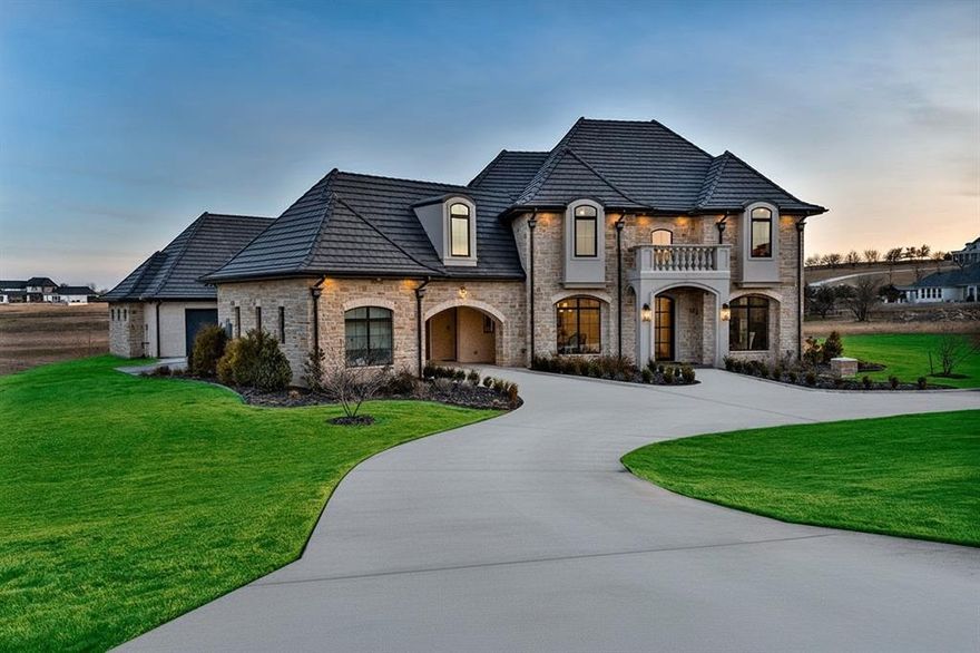 Welcome to refined luxury living in the prestigious LaMadera neighborhood of Aledo. Situated on 2 beautifully manicured acres, this 5,801 square foot new construction estate by John Askew Custom Homes, offers an exceptional blend of timeless elegance and thoughtful design. 
Featuring 5 spacious bedrooms, 4 full bathrooms, and 1 half bath, this home was crafted for both elevated entertaining and everyday comfort. Hand-scraped wood floors flow throughout the main living areas, adding warmth and character to the grand scale of the home.
The chef’s kitchen showcases custom cabinetry, designer finishes, and an oversized island that anchors the space while opening seamlessly to the living and dining areas. A formal dining room provides an elegant setting for gatherings, while the private study or library offers a quiet retreat for work or reading.
The primary suite is a true sanctuary with a spa-inspired bath and a custom closet complete with a built-in makeup vanity. Upstairs, you’ll find a dedicated media room plus an additional sitting or bonus room, creating flexible space for relaxation, recreation, or hobbies.
Designed for year-round enjoyment, the outdoor living area features a fully equipped outdoor kitchen and fireplace, ideal for hosting under the Texas sky while overlooking the expansive acreage.
Situated in LaMadera within acclaimed Aledo ISD, this stunning property blends elegant architecture, generous acreage, and elevated living in a premier Aledo community.