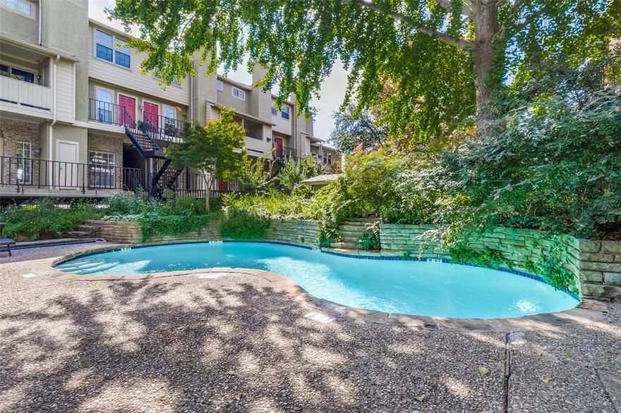 For Sale and For Lease. A 1-of-1 Opportunity in the Heart of the M Streets

Just off vibrant Greenville Avenue—steps from iconic restaurants, bars, and coffee shops—this rare condo is your invitation into Dallas real estate. Tucked back in a quiet, tree-lined enclave, the building is wrapped in the serenity of mature oaks that sweep dramatically over a sparkling pool. It feels like a hidden oasis in the middle of the city—an amenity nearly impossible to find in the M Streets at this price point.

Inside, every window frames green views of manicured lawns, trees, and blooms, giving the home a sense of calm and openness. The main floor is designed for connection and ease, with a living room anchored by a fireplace, a built-in bar for entertaining, a dining area, and a well-appointed kitchen. French doors open to your private balcony—perfect for morning coffee or sunset wine.

Upstairs, the oversized primary suite spans the entire second floor, offering space for a home office, gym, or nursery. The thoughtful two-and-a-half-bath layout lives much larger than expected, with smart storage throughout. Enhanced over the years with modern updates while retaining timeless charm, this home combines character, comfort, and convenience. With gated garage entry and secured pedestrian access, privacy is ensured.

This is more than a condo—it’s a lifestyle. A rare chance to live in Dallas’ most vibrant neighborhood, with every city delight just beyond your doorstep.