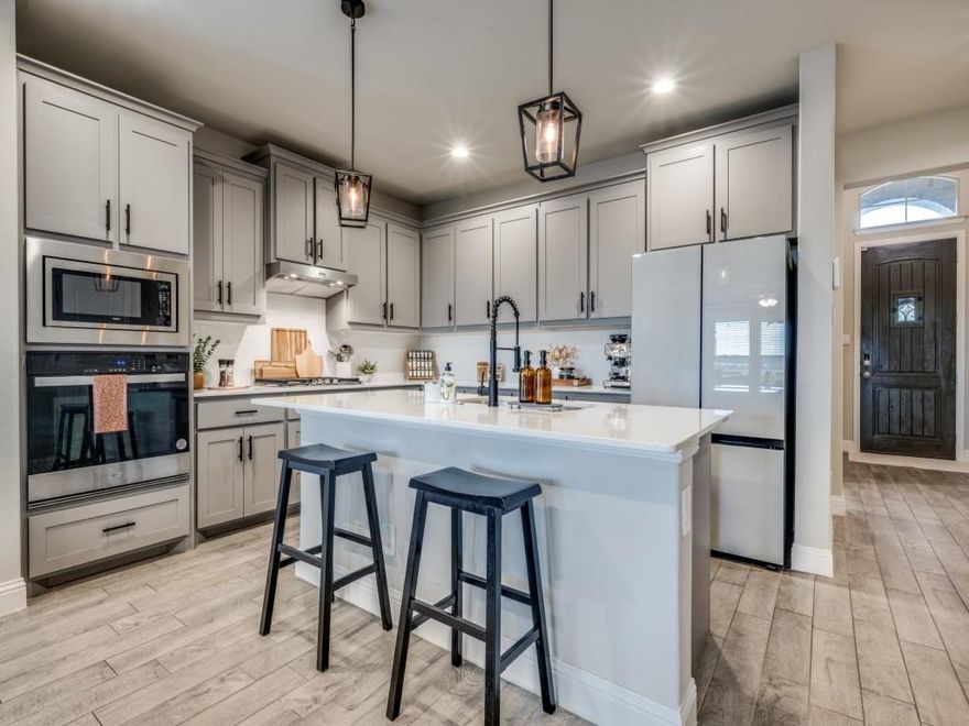 Fall in love with this stunning two-story home in the sought-after Avalon community in Argyle! This beautifully maintained residence offers 5 spacious bedrooms, 3.5 bathrooms, and an expansive game room—perfect for everyday living and entertaining.

From the moment you walk in, you’ll be welcomed by a bright, open-concept layout that seamlessly connects the living, dining, and kitchen areas. The chef’s kitchen is a true showstopper, featuring a large center island, quartz countertops, stainless steel built-in appliances, gas cooktop, 42” upper cabinets, pendant lighting, and a walk-in pantry.

The luxurious primary suite is tucked away on the main level and features a spa-inspired bathroom with dual vanities, a garden tub, oversized shower with seating, and a large walk-in closet. Upstairs, you’ll find additional bedrooms, full bathrooms with quartz vanities, and a huge game room perfect for movie nights or playtime.

Thoughtful upgrades throughout include wood-look tile flooring in all the right places, a tankless water heater, smart home features, a mud bench, and a full sprinkler system. Enjoy the outdoors year-round with a covered patio, landscaped yard, and charming front coach lights.

Conveniently located near Historic Downtown Denton, DFW Airport, Texas Motor Speedway, Tanger Outlet Mall, and countless shops and restaurants—this home offers the perfect balance of comfort, style, and location. Don’t miss your chance to make it yours!