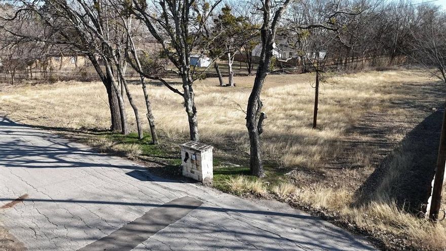 Build-Ready lot in a perfect location in Azle, Texas. Just down the street from Cross Timbers Golf Course, very close to schools and just a couple miles from HWY 199, this lot has wonderful potential for an affordable place to build. This property has been subdivided into two lots. R0126692 is .276 acres that sits next to the other subdivided lot; R013121 is .465 acres. The option is there to purchase both lots and re-plat them into 1 lot or keep them separate and sell the other. Home must be 1600 sq ft per city restrictions. No mobile homes, barndos have specific regulations they must meet. City sewer hookups and power pole on site. Property has wonderful opportunities and just waiting for a beautiful home and family to take up residence!