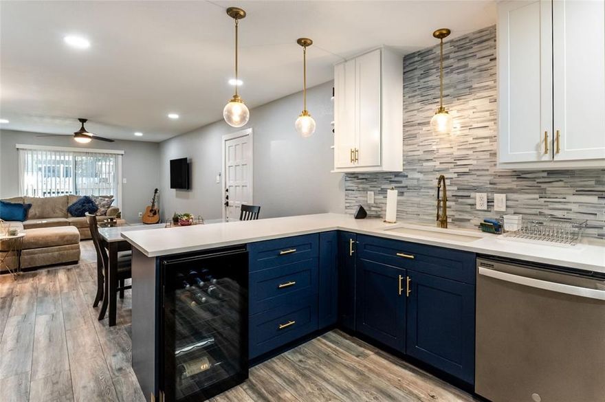Welcome to easy, stylish living in this beautifully updated 2-bedroom, 2-bathroom first-floor condo, perfectly positioned poolside with a private patio and small grassy area. Step inside to an open, light-filled layout featuring durable luxury vinyl plank flooring throughout, designer paint, modern lighting, and upgraded baseboards throughout. The custom kitchen is a true standout, showcasing quartz countertops, sleek slate appliances, dual tone cabinets, a breakfast bar, and a built-in wine cooler—perfect for everyday living and hosting alike. Both bathrooms have been fully renovated with stylish tile work and contemporary vanities, while updated doors—including eye-catching barn doors—add a unique and modern touch. New windows and a sliding glass door bring in abundant natural light and provide seamless access to your outdoor space with tranquil pool views. Enjoy the convenience of a built-in laundry area with a stackable washer and dryer. Washer, dryer, refrigerator and wine fridge all convey! One covered parking space adds extra ease. Located just minutes from shopping, dining, Highway 75, and entertainment, this move-in-ready condo offers the perfect blend of comfort, style, and location.