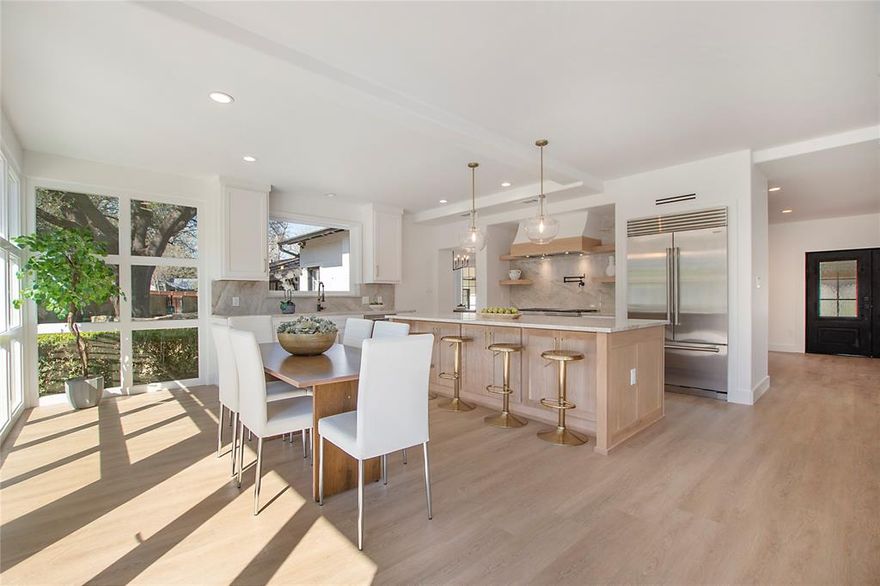 Own a Piece of Dallas History! Have you dreamed of living in a home that carries a rich legacy? Charles Dilbeck, Dallas’ most renowned architect designed this masterpiece. This property was owned by the prominent Dealey family, known for their deep roots in Dallas. The Dealeys commissioned this home as a lasting symbol of their family’s wealth and status. This Dilbeck designed home has been meticulously renovated and updated, blending historic charm with modern luxury. Perched on a 0.731-acre hilltop lot in North Dallas' Preston Hollow private school corridor, this home offers both exclusivity and convenience. A circular driveway leads to an elegant porte-cochère and iron double doors, setting the tone for the stunning interiors. Inside open-concept spaces are filled with natural light from floor-to-ceiling windows and accordion doors that bring the outdoors in. New flooring and designer lighting enhance the ambiance while the professional gourmet kitchen stuns with new custom cabinetry, Taj Mahal Quartzite countertops, 48 inch dual-fuel Wolf range and 42 inch Sub-Zero refrigerator. The primary suite offers a private retreat with fireplace, spacious walk-in closet and a spa-like en-suite bathroom. Full-size Guest House includes a kitchen, Café appliances and a private bath, perfect for guests or rental income. The sprawling backyard is an oasis of tranquility centered around a newly re-plastered and tiled pool, perfect for cooling off on warm Texas days. The outdoor island area makes hosting summer gatherings effortless. Whether lounging by the pool, dining under the stars, or enjoying a quiet morning coffee on the terrace, this outdoor retreat is designed for ultimate enjoyment and relaxation. Other features include security cameras, freshly painted interiors and exteriors, EV charger and energy-efficient updates. Don’t miss this rare chance to own a piece of Dallas history while enjoying the finest in contemporary living.