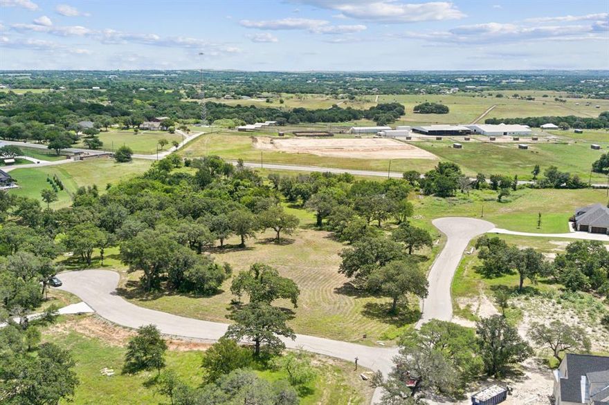 Welcome to 600 Nyoka Bend, a serene 2-acre homesite located in the beautiful Bar H Ranch community of Weatherford, Texas. This expansive corner lot offers the perfect blend of natural beauty and modern convenience, making it an ideal setting for your custom dream home. Surrounded by mature post oak and live oak trees, the property provides a picturesque backdrop and a sense of peaceful seclusion. The community features a gated entrance, underground utilities, and access to AT&T fiber optics, ensuring privacy and high-speed connectivity. With no set timeline to build and the freedom to bring your own builder, you can design at your own pace, provided the home meets the community’s HOA requirements. Located just minutes from Weatherford High School, shopping, and dining, this lot offers the charm of country living with the convenience of nearby amenities. Don’t miss this opportunity to create your ideal retreat in one of Weatherford’s most desirable neighborhoods.
