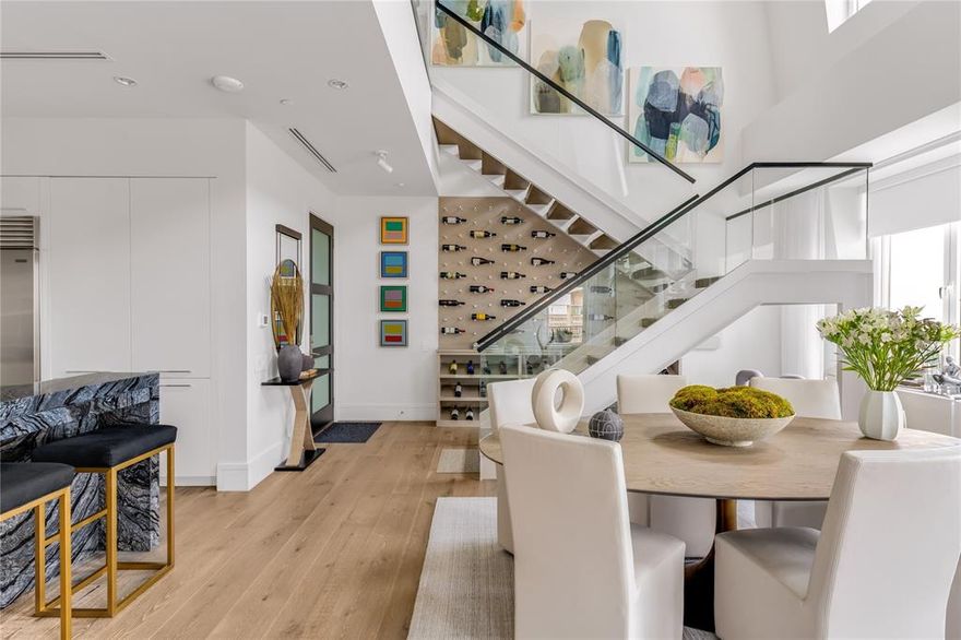 Experience luxury living at its finest. This sleek contemporary penthouse features a soaring two-story living area, a custom wine wall, a floating staircase, and a wrap-around terrace. Two primary suites offer spacious spa-inspired baths and custom walk-in closets. The newly added media room and private office are enclosed in glass to maximize natural light. The kitchen showcases a striking Silver Wave granite island and European style cabinetry. Designed by architects X+III and built by Hudson Construction Group in 2021, this residence has many additional updates. Two reserved parking spaces and access to the Vendome’s luxury amenities: a resort-style pool with cabanas, library, entertainment room, three guest suites, fitness center, dog park, and 24-hour valet and concierge, and more.