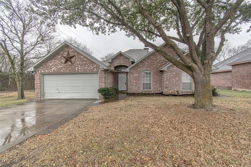 Don’t miss this beautiful single-story home in Glenn Heights, TX, featuring 3 bedrooms, 2 full bathrooms, and a 2-car garage with a long enough driveway to park 4 additional vehicles. Situated on an oversized lot at the end of the street, this home offers added privacy and a desirable setting rarely available.
Inside, you’ll find a semi-open floor plan ideal for both everyday living and entertaining. The home is enhanced by vaulted ceilings, laminate hardwood and tile flooring, a cozy floor-to-ceiling stone gas fireplace, and abundant natural light throughout. The chef’s kitchen is already equipped with stainless steel appliances and granite countertops providing both style and functionality. The seamless flow from the kitchen and dining area to the back patio enhances indoor-outdoor living, perfect for hosting or enjoying quiet evenings at home. Glenn Heights offers a quiet suburban environment with parks, community events, and easy access to major corridors like I-35E, meaning shopping, entertainment, schools, and healthcare options are all within a few short miles.