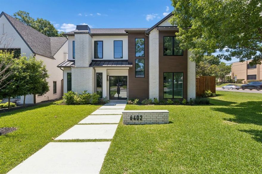 Built by The Cyrus Collection, this brand-new Lakewood estate presents a rare opportunity to own luxury new construction in one of East Dallas’ most iconic neighborhoods. Offering 5 bedrooms, 5 full bathrooms, and 1 half bath, the home pairs polished contemporary architecture with a warm, designer-curated finish palette that feels both elevated and timeless.
The refined modern exterior opens to interiors defined by light wood flooring, striking black accents, custom cabinetry, and thoughtfully selected finishes throughout. Designed for both everyday living and entertaining, the expansive floor plan features two downstairs living areas, each with its own fireplace. The main living room showcases soaring vaulted ceilings, built-in cabinetry, and seamless flow into the chef’s kitchen and covered patio beyond.
At the heart of the home, the kitchen blends beauty and functionality with integrated appliances, an oversized Taj Mahal leathered quartzite island, walk-in pantry, wine refrigerator, and adjoining butler’s pantry connecting to the formal dining room. Two downstairs bedrooms with ensuite baths offer flexibility for guests or multigenerational living, along with a first-floor laundry room.
Upstairs, an additional family room with built-in cabinetry and a dedicated media room provide exceptional secondary living spaces. Two secondary bedrooms feature private ensuite baths, while the luxurious primary suite offers a spa-inspired bath, oversized walk-in shower, soaking tub, dual vanities, expansive walk-in closet, and an additional upstairs laundry room.
Outdoor living is equally impressive with a covered patio and fireplace, creating a seamless extension of the home for year-round enjoyment. Ideally situated moments from White Rock Lake and Lakewood’s premier dining, shopping, and entertainment destinations, this exceptional residence delivers modern luxury living in the heart of East Dallas.