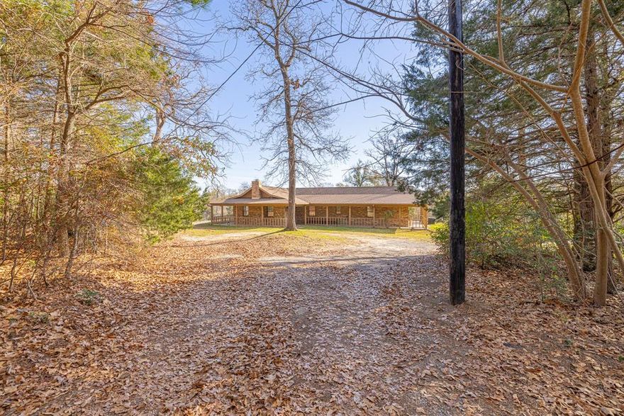 Nestled north of Buffalo in the Lanely area, this 11-acre property boasts a mostly wooded haven with a natural spring for those seeking a quiet country lifestyle. The 2 or 3-bed, 2-bath brick home exudes charm with a wraparound porch, creating a seamless outdoor connection. The open concept living space is bathed in natural light, featuring a cozy brick fireplace, a high vaulted ceiling with wood beam detail, and scored concrete flooring. The kitchen has been stylishly updated with granite countertops & tile backsplash ('21) & opens to a breakfast area overlooking the scenic backyard. The primary bedroom is spacious with a walk-in closet & private bath with a soaking tub & separate shower. There's a large 2nd bedroom & a 3rd small bedroom or office space. Outside, enjoy a double carport & a storage building with electricity. A second driveway leads to a slab, ready for a shop or 2nd home.  New roof Aug 2023, new DW, disposal & water heater '23. Imagine the possibilities!