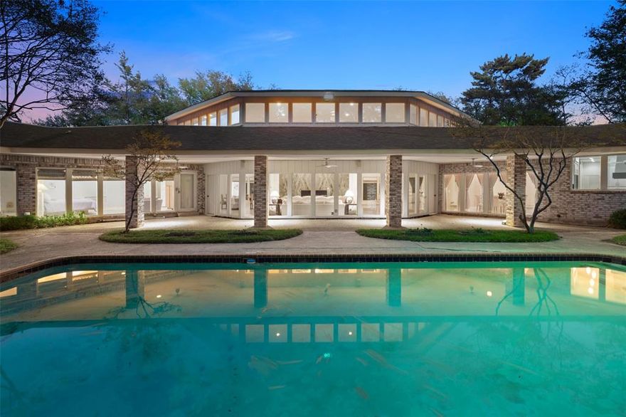 Welcome to the ultra private Inwood Estates cul-de-sac in the heart of Old Preston Hollow. As you approach this expansive, elevated property, a dramatic sweeping circular drive and mature landscaping with towering lighted trees lead to an impressive grand porte-cochère with striking mid-century architecture.

A unique wood double-door entry opens to a breathtaking soaring foyer with marble floors, setting the tone for this extraordinary residence. The elegant, symmetrical floor plan offers gracious transitions around a sensational 20-foot marble fireplace into a magnificent entertaining area with windows framing spectacular pool views.

Designed for both refined gatherings and relaxed living, the living room features a wet bar, generous sitting areas, a piano space, and a game table area. One wing opens seamlessly into a formal dining room overlooking the pool and gardens.

The oversized kitchen is complemented by a sunlit morning room, large pantry, and separate silver closet. Accommodations include a private guest suite and a versatile room with full bath opening to a secluded courtyard, ideal as a library or study.

A fully independent two-bedroom guest apartment offers a living room, kitchen, and bath, perfect for extended stays or multigenerational living. The three-car garage is complete with a full bathroom.

A distinctive octagon-shaped vestibule connects the bedroom wing and serene primary suite. Two spacious ensuite bedrooms enjoy courtyard views, while the primary offers pool views, a large bath with sunken tub, and dual bath layout with separate closets.

The backyard showcases a covered patio overlooking the pool, plus a 625 sq ft guest or studio suite with full bath and private patios. Lush gardens, mature trees, and winding walkways create exceptional privacy.

Set on a one-acre lot, this home was originally built by renowned architect Hal Anderson, and has been meticulously maintained and thoughtfully updated.