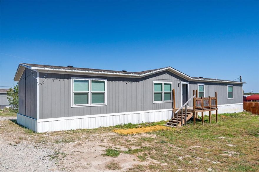 Opportunity abounds with this home!  Whether you are looking to purchase your first home, need more space for the family, or looking for investment property, this house can be what you need it to be.  With over 2,000 square feet, this double-wide manufactured home was installed in 2023 and sits on two lots in the Oak Hills subdivision.  Walking in the front door, guests are greeted with an open floor plan with distinctive living room, kitchen and a flex space that can be used a dining room, office space, or whatever the family needs.  Home features 4 bedrooms with 2 full bathrooms.  Primary bedroom is on one side the home with a built in desk and large bathroom with walk in closet.  Other 3 bedrooms are on the opposite side of the home with two of the rooms featuring walk in closets.  Guest bathroom has built in linen shelving.  Kitchen features a large island that sits 2 barstools and has incredible storage space.  Utility room is located off the kitchen with door to the backyard.  Natural light fills the home.  Lots have been cleaned off for easy maintenace.  Home can be financed FHA or VA.  This is a one-owner home looking for its next family...come see what it can offer you!