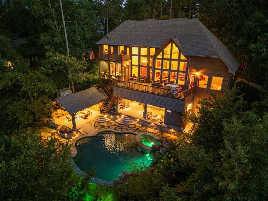 Absolutely stunning waterfront estate on Lake Cypress Springs, located in the highly sought-after El Dorado Subdivision. This remarkable property defines lakefront luxury, offering a rare combination of space, design, and unbeatable views. With 5 bedrooms and an additional flex room that can serve as a sixth bedroom, office, or game room, this home is ideal for entertaining and hosting guests. The main living room is the heart of the home, featuring a soaring wall of windows overlooking the main lake—offering one of the most breathtaking views on the water—and a gorgeous floor-to-ceiling stone fireplace that adds warmth and character. The chef’s kitchen is equally impressive, showcasing a gas cooktop, SS appliances, custom cabinetry, granite countertops, and an oversized island perfect for gatherings and prep space. The primary suite offers lake views, direct access to the expansive patio, and a spa-like en-suite with a large walk-in closet. Upstairs includes three additional bedrooms, a versatile loft area that can be used as a second living space, and access to a fabulous screened-in balcony for enjoying lake breezes. Rustic charm meets refined luxury throughout, and the outdoor living space is truly one of a kind. The oversized back deck overlooks an eye-catching infinity-edge pool that appears to flow seamlessly into the lake. Nearby, you’ll find two covered patio areas—one with a cozy fireplace and TV, and another with a pool room equipped with a sink, refrigerator, and half bath. Custom boathouse is a standout feature, complete with party deck, two boat slips, and room for two jet skis. Property includes a 1.1-acre waterfront lot, plus four additional lots across the street, offering over 4.5 acres total—perfect for adding a guest house or pickleball court, subject to approval).Offered fully furnished, this home also includes a 2021 Malibu Ski Boat, 2013 Bennington Tritoon, and two 2021 Yamaha Jet Skis—a turnkey opportunity to live the ultimate lake lifestyle