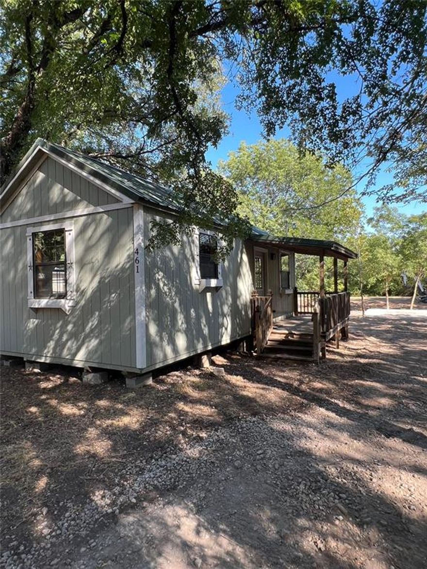 Adorable cabin with 1 bedroom, a full bathroom and combined living and kitchen area, on a beautiful country .182 acre lot in the county. Ready to move in. Wood siding on the inside, with metal ceilings. Plenty of land for an add-on and 550 feet of concrete pad. Spend your weekends or full time living at the lake. Backyard access with a path to one of the two private community lakes (Western Lakes) with boat docks and ramps. Has all utilities and current survey. Home and land is to own, and not to lease or rent. Community center with an in-ground pool and playground area. HOA only $36 a year to cover the private lakes (Western Lakes off Tin Top Road) and pool amenities.