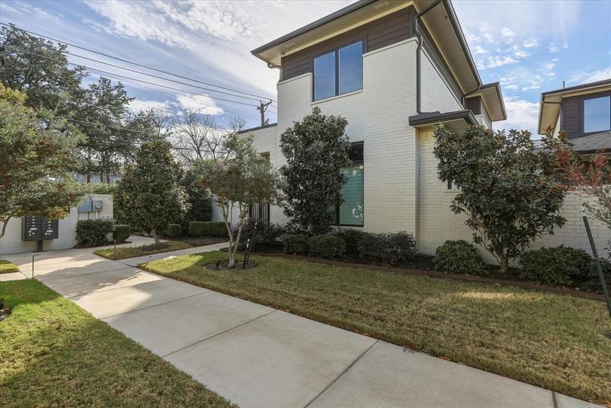 Located in Fort Worth’s highly sought-after River District, this modern contemporary home sits on a prime corner lot in The Grove and features a standing seam metal roof with a 3-bedroom, 3.5-bath open-concept layout designed for effortless living and entertaining. The kitchen offers a spacious island, recessed and pendant lighting, a five-burner gas cooktop, and abundant cabinetry with glass fronts and built-in dining storage. The main living area showcases engineered wood flooring, a gas-log fireplace, and a statement chandelier, complemented by neutral finishes throughout. The primary suite includes wood flooring and a spa-inspired bath with dual vanities, garden tub, separate shower, marble-look tile, and a large walk-in closet. Upstairs is a second living or game room and two additional bedrooms, each with walk-in closets and private baths. Outdoor living is highlighted by an oversized patio with patterned tile, low-maintenance turf, and a small dog run, plus an alley-access rear-entry two-car garage with epoxy flooring and a new HVAC system installed in 2024. Ideally located just steps from Trinity Trails and moments from the River District’s premier dining, shopping, and cultural destinations, this home offers a rare blend of modern design and walkable outdoor lifestyle.