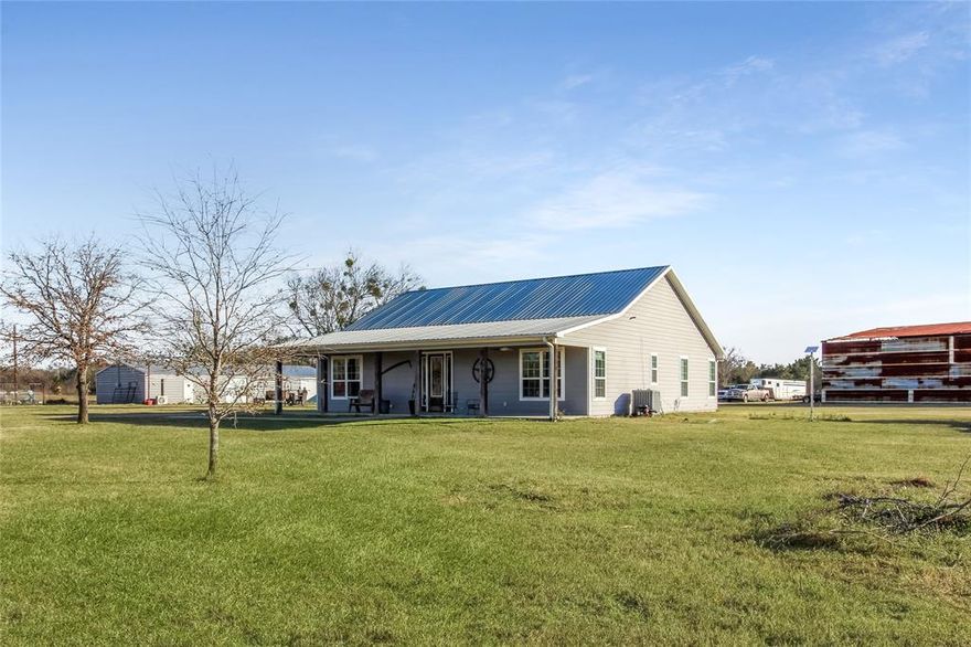 Beautifully remodeled 5-bedroom, 3-bath home on 5 cross-fenced acres in Scurry, TX, located in Kemp ISD with a pond! Built in 2015 and completely move-in ready, this 2,068 sq ft home offers space, flexibility, and functionality ideal for large families, multi-generational living, or those needing rooms for a home office, gym, playroom, or hobby space.  The inviting entryway opens to a bright, open living area featuring laminate wood flooring throughout and a cozy ventless propane fireplace. The dining area showcases a charming white shiplap accent wall, while the kitchen is a true standout with refinished white cabinets, new quartz countertops, a two-seat eat-in island with drawers, outlets, and a trash pull-out, mosaic tile backsplash, and abundant natural light from large windows and glass double back doors.  The split layout provides privacy and versatility. One side of the home features three bedrooms and a full bath. The opposite side offers an additional bedroom with a full bath and the spacious primary suite. The primary bedroom includes room for a sitting area and leads to a spa-like bathroom with double vanities, a large walk-in closet, an added linen closet, and an impressive oversized walk-in shower with dual shower heads.  Recent upgrades include new flooring, paint, trim, fixtures, switches, doorknobs, keyless entry on front and back doors, refinished cabinets, new tile and backsplash, quartz countertops, and fully remodeled primary and shared bathrooms with custom cabinetry, tile, and glass.  Outside improvements are equally impressive: a rustic 16x18 barn used as an office-man cave, pre-plumbed for a bathroom; a 30x70 insulated show barn with mini-split AC-heat, tankless water heater, washer dryer hookups, shop sink, five stalls, three roll-up doors, two man doors, separate electric meter, and bathroom plumbing in place; plus a 60x60 pole barn with half concrete, ideal for a future MIL suite, apartment, or pool room.