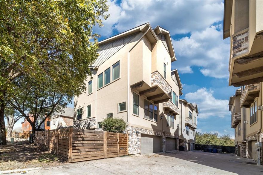 Stylish corner-unit townhome in a prime East Dallas location near White Rock Lake, Santa Fe Trail, and the Dallas Arboretum. This home offers a smart, functional layout with bright, open living spaces and elevated finishes throughout. The main level features 10-foot ceilings, oak hardwood floors, and a gas fireplace, creating a warm and inviting space for both relaxing and entertaining.

The kitchen is designed for everyday living with granite countertops, stainless steel appliances, and ample wood cabinetry, all open to the living and dining areas. The primary suite is generously sized and feels like a true retreat, complete with tall ceilings, crown molding, and a spa-inspired bathroom with dual vanities, a soaking tub, and a separate shower. A second bedroom with its own full bath is perfect for guests.

You’ll also enjoy a dedicated laundry room, an attached two-car garage, and a versatile bonus space ideal for a home office, gym, or media room. The highlight is the fourth-floor walk-out rooftop deck with peaceful treetop views—perfect for morning coffee or evening unwinding. With low HOA fees and a location walking distance to trails, shopping, and outdoor recreation, this move-in-ready townhome offers the ideal blend of comfort, style, and convenience.