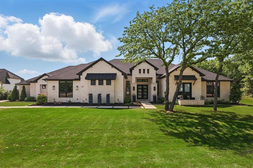 Experience the epitome of quiet luxury in the exclusive 100-acre gated community of Pepper Creek Ranch in Flower Mound, TX, featuring 50 custom homesites and 50 acres of green space—treed common areas, rolling hills, trails, fishing pond, neighborhood amenities and highly acclaimed Argyle ISD, just 10 miles North of DFW International Airport, positioned between Grapevine and Lewisville Lakes! This spectacular Victor Meyers custom single-story home provides a serene atmosphere with effortless sophistication. Boasting over 4300 sq ft it includes 4 bedrooms all with ensuite baths, a dedicated study and media room, an outdoor living space and a custom-designed pool with waterfall all nestled on a private treed greenbelt lot. Enjoy thoughtful details, quality craftsmanship and premium materials throughout! The seamless flow between indoor and outdoor living spaces is bathed in natural light, showcasing 12-foot ceilings, wood beam ceiling treatments, multiple French glass doors, floor-to-ceiling windows, light oak wood flooring and designer lighting. Highlights include a wine grotto, two fireplaces, an outdoor kitchen with a grill, remote controlled retractable privacy screens for year-round entertaining! The chef's kitchen is equipped with two islands, stainless steel appliances, a 6-burner gas range, side-by-side commercial-sized refrigerator-freezer, double ovens, stacked white cabinets with glass fronts, oak floating shelves, a designer backsplash and quartz countertops. Simply Gorgeous! The primary suite features a spa-like soaking tub and rain-shower, a coffee bar, dual closets and private patio-pool access! Additional features include handicap-accessible 4th bedroom, two surround sound systems, a security system with cameras, a generous laundry room, extensive custom built-ins and storage plus an-oversized side entry 3 bay garage.  Truly perfection!