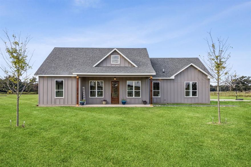 Discover serene country living with this stunning one owner custom-built farmhouse nestled on over six tranquil acres in Wills Point, TX. This exquisite property has 3 bedrooms, 2.5 baths, and an oversized 2-car garage, offering modern comfort wrapped in rustic charm. Step inside to a light and airy interior, where thoughtful design and generous windows flood the space with natural light. The home's open concept layout, seamlessly blends the living, dining, and kitchen areas, creating an inviting space perfect for both relaxing and entertaining. The gourmet kitchen is a chef's dream with stainless appliances, elegant countertops, and a large island providing ample storage & prep space. Adjacent to the kitchen, enjoy casual meals in the dining area while appreciating the serene views of the surrounding landscape. The primary suite is a private retreat, featuring a luxurious en-suite bath with spa-like amenities, including a soaking tub, separate shower, and dual vanities. The two additional bedrooms are generously sized, offering comfort and flexibility for family or guests. A conveniently located half bath adds to the home's functionality. Outside, the property presents an expansive canvas of more than six acres, offering endless possibilities for outdoor activities, gardening, or simply enjoying the peace and privacy of rural living. The farmhouse's charming exterior is complemented by scenic vistas and mature trees, providing a picturesque backdrop for your new home. This extraordinary property combines the allure of a classic farmhouse with the conveniences of modern living, making it a perfect sanctuary away from the hustle and bustle. Whether you're seeking a peaceful retreat or a spacious home to make your own, this Wills Point gem is a rare opportunity not to be missed. Search address on Youtube for video.